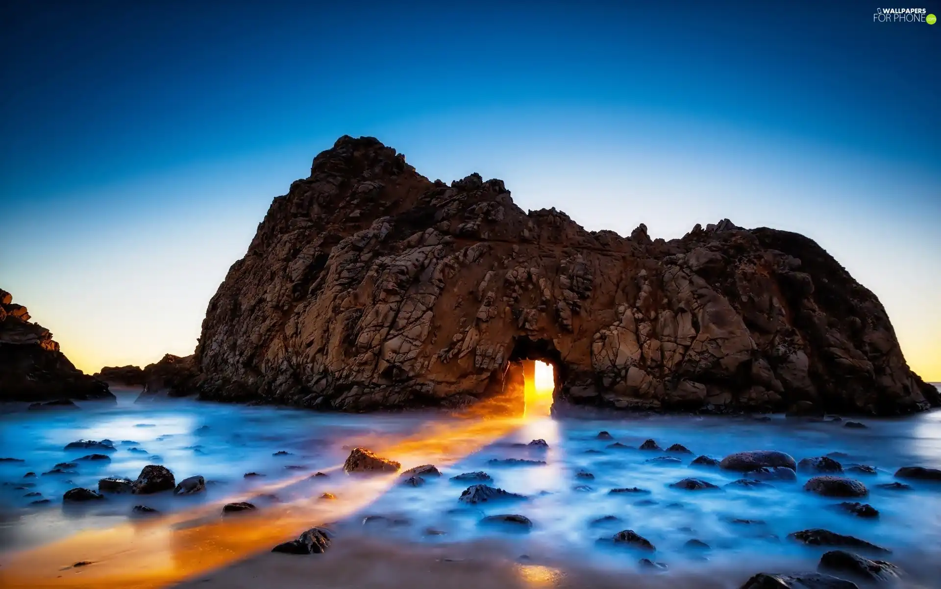 sea, light breaking through sky, California, rocks