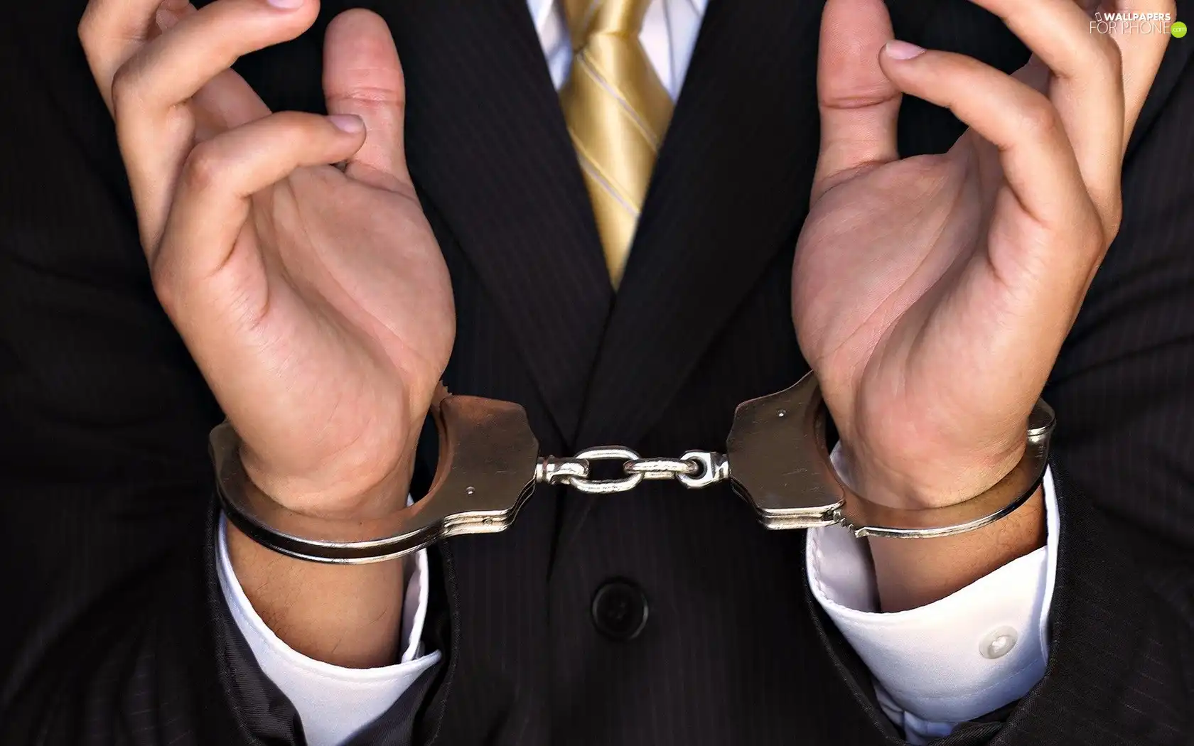 a man, hands, handcuffs, suite