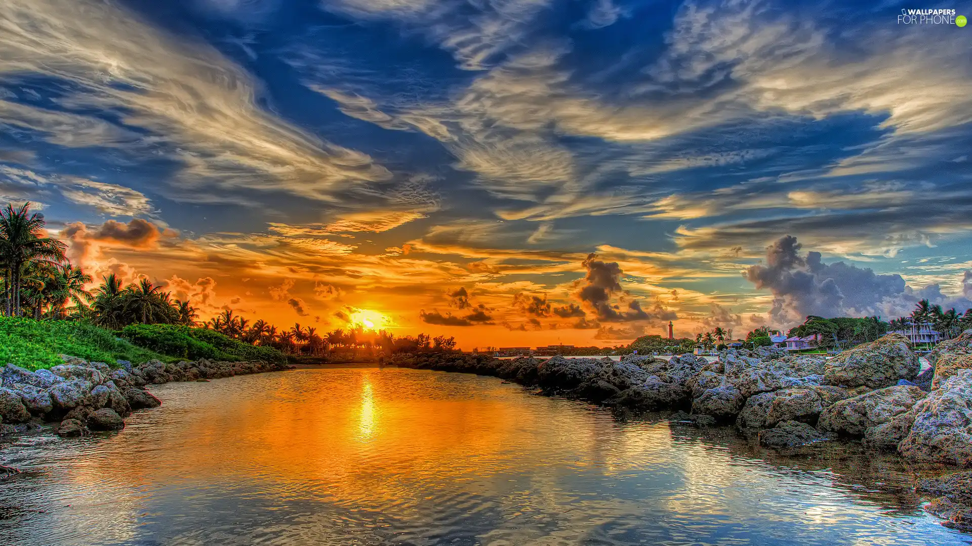 sun, clouds, water, buildings, rocks, west