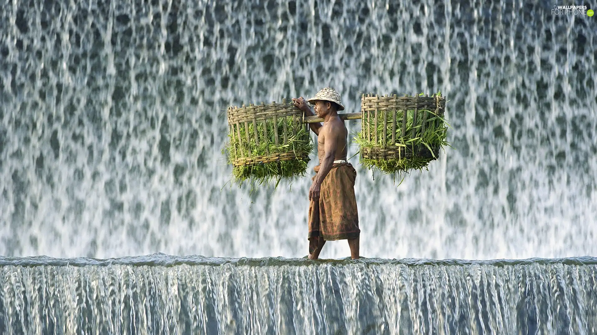 Baskets, a man, waterfall